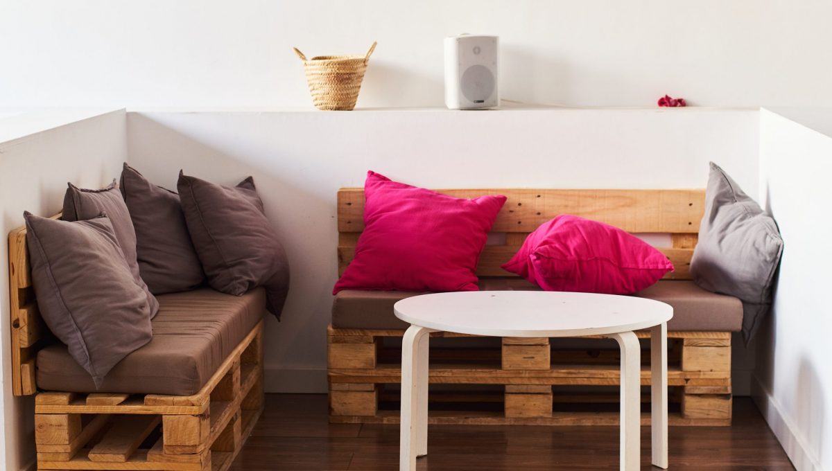 Wooden pallet sofas with colorful pillows.